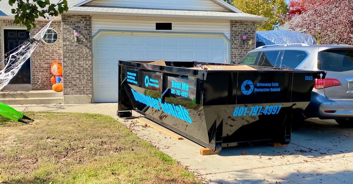 Residential home with small dumpster rental on driveway in Utah