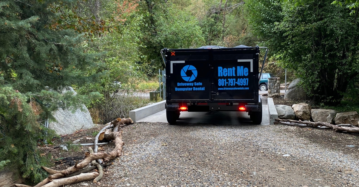 Roll off dumpster safely placed on wooden blocks in a residential driveway