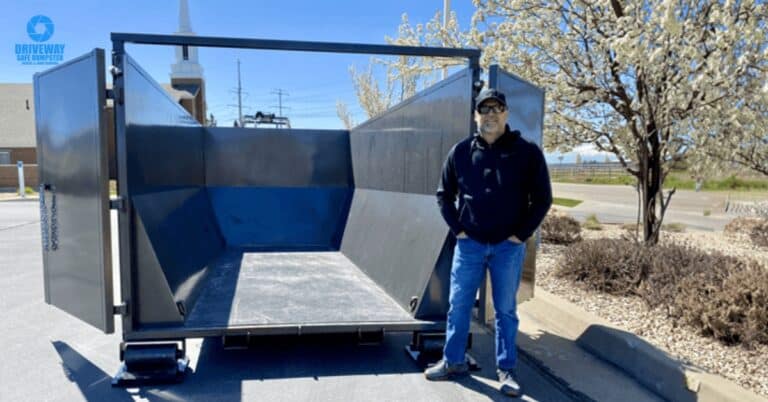 Driveway-safe dumpster placed on wooden planks in a driveway