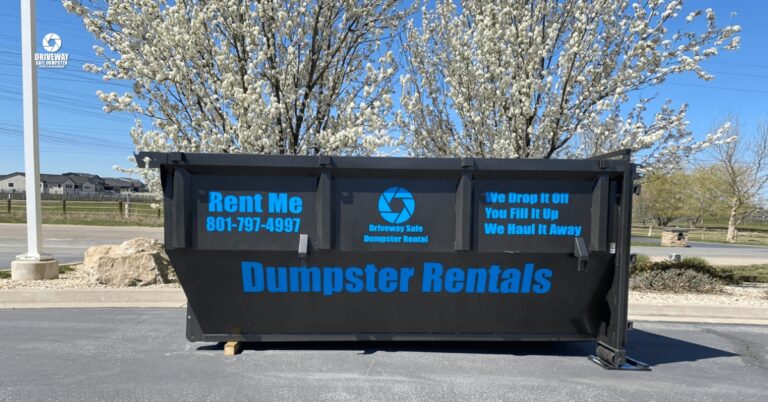 Residential-friendly roll-off dumpster placed safely on a driveway in Utah.