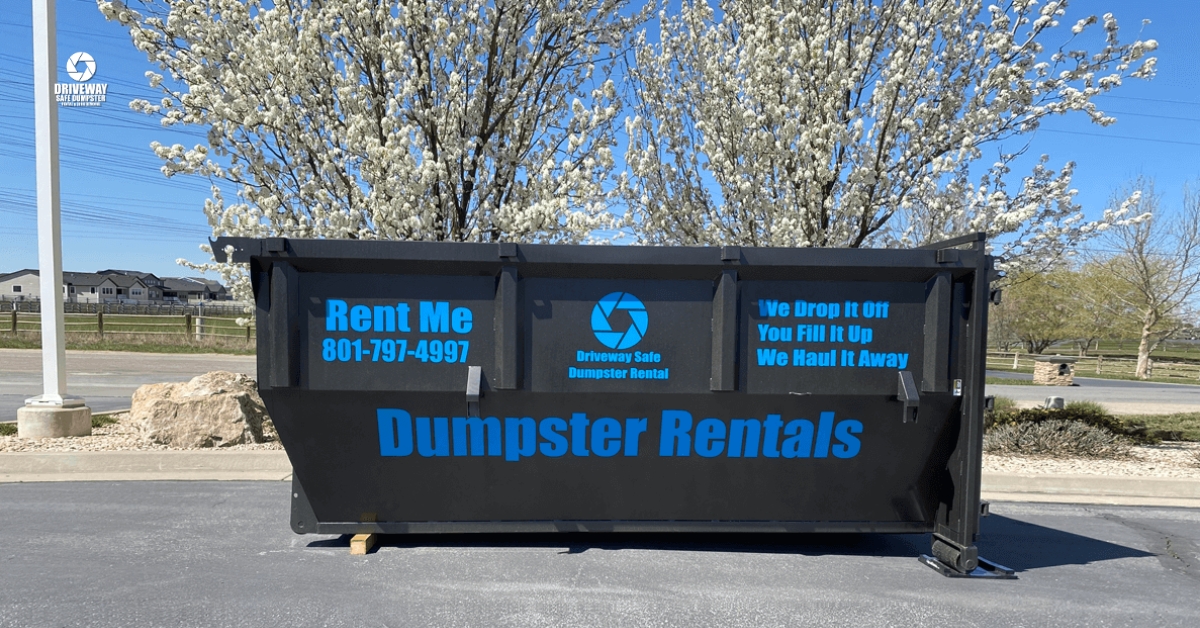 Residential-friendly roll-off dumpster placed safely on a driveway in Utah.