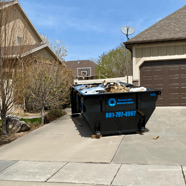 Residential dumpster filled with furniture and household junk